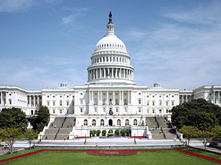 A gleaming white pillared structure with a domed top rests on a grassy surface.