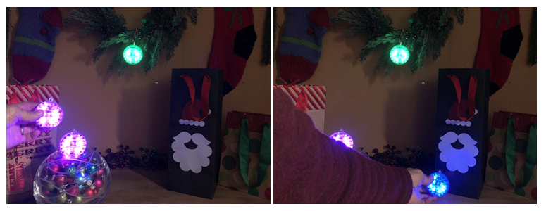 Left, table decorated with festive elements. One lit ornament is hanging on a garland, another is sitting in a bowl, and a third is being held in a hand. Right, same scene, except the hand has moved and the ornament is now a different color.